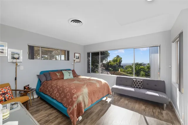 a bedroom with a bed and a couch