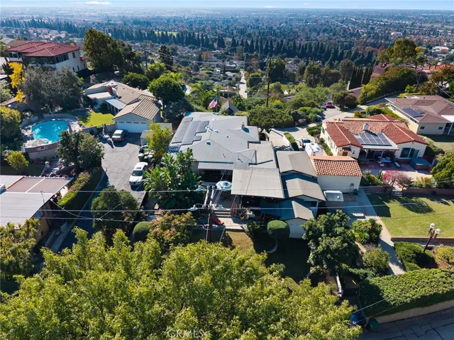 an aerial view of multiple houses with yard