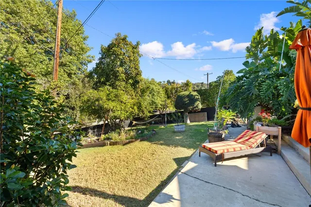 a view of a backyard with sitting area
