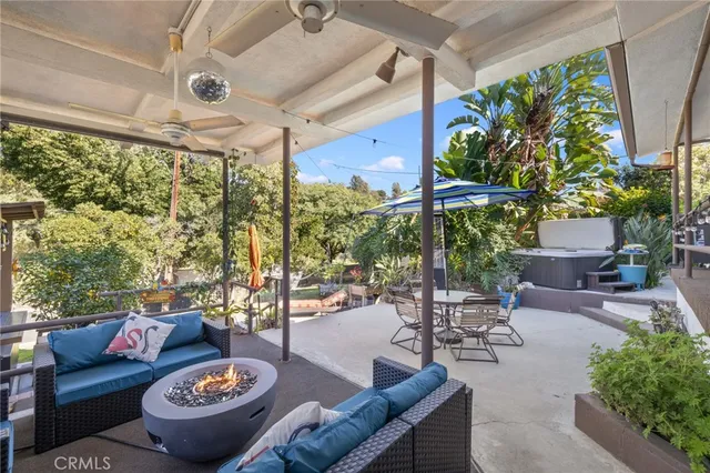a living room with patio furniture and a potted plant