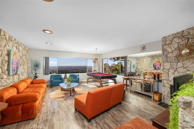 a living room with furniture kitchen and a fireplace