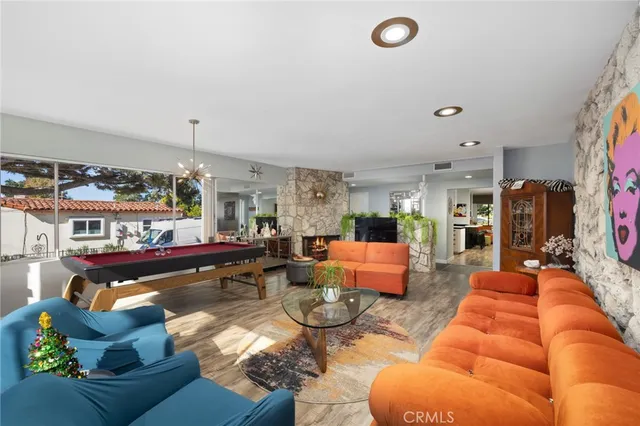 a living room with fireplace furniture and a large window