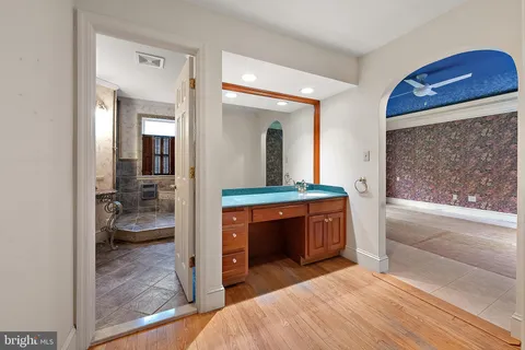 a bedroom with a bed and a view of living room