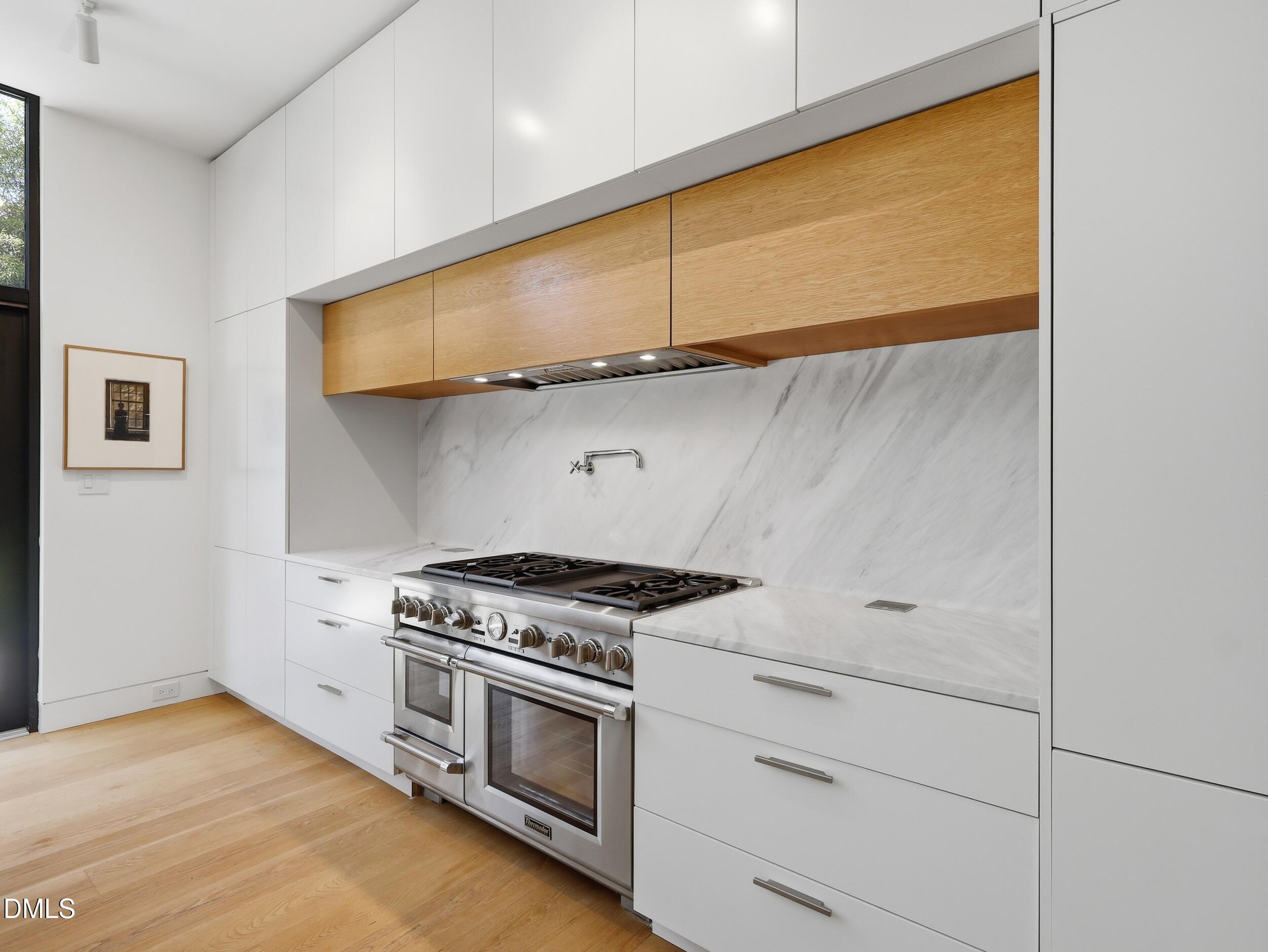 117 Hillcrest Road Raleigh, NC 27605 - Photo 13 of 80 a kitchen with white cabinets and a stove top oven