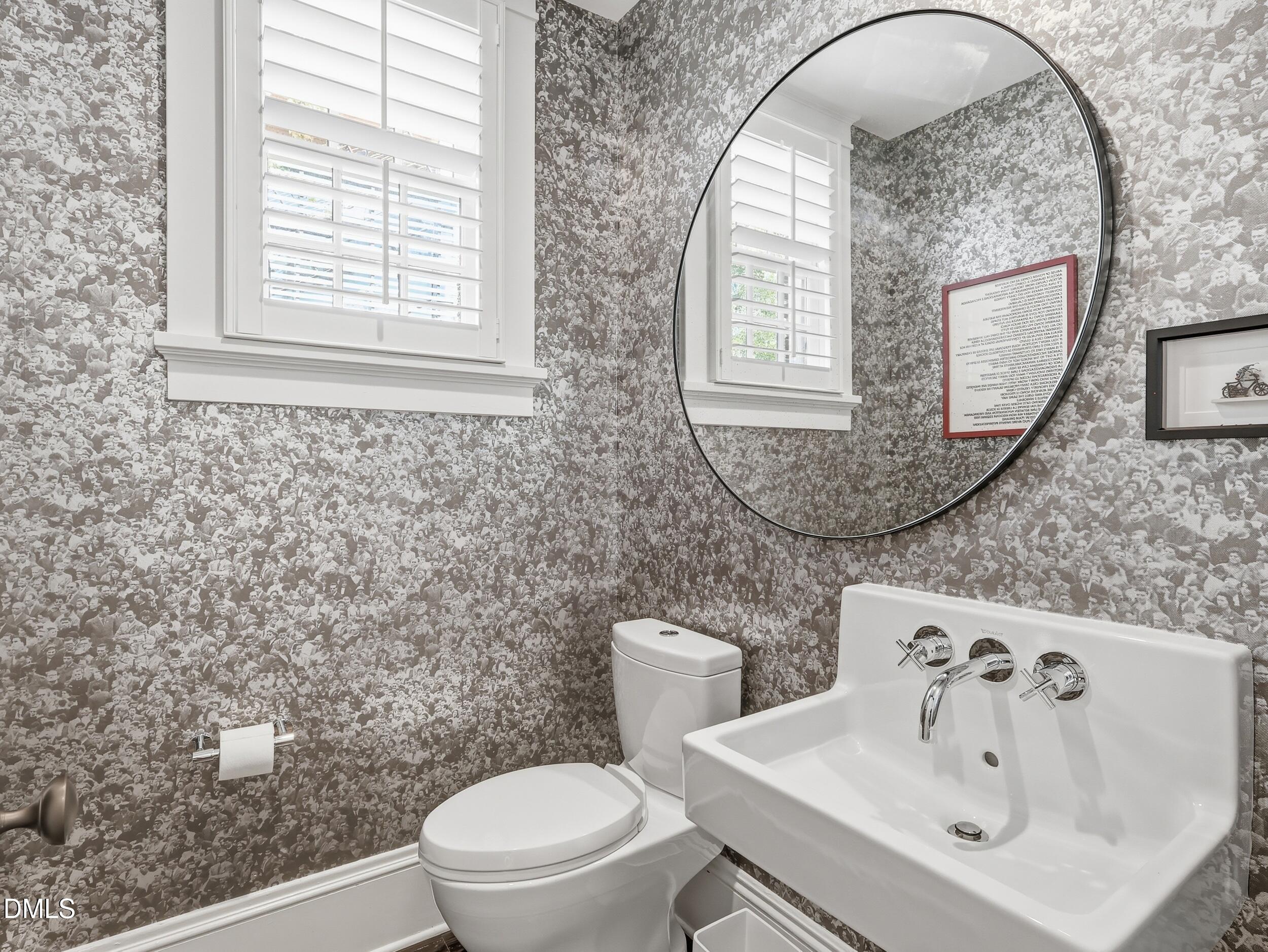 117 Hillcrest Road Raleigh, NC 27605 - Photo 31 of 80 a bathroom with a sink a toilet and a mirror