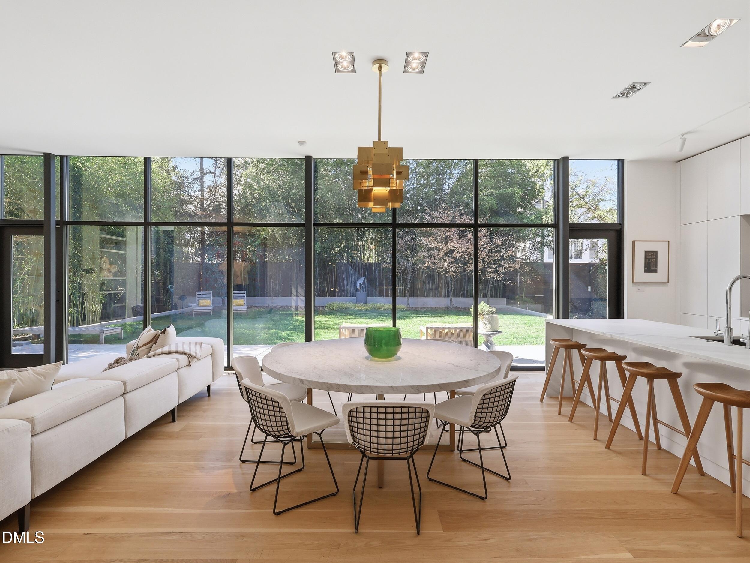 117 Hillcrest Road Raleigh, NC 27605 - Photo 4 of 80 a dining room with furniture a chandelier and wooden floor