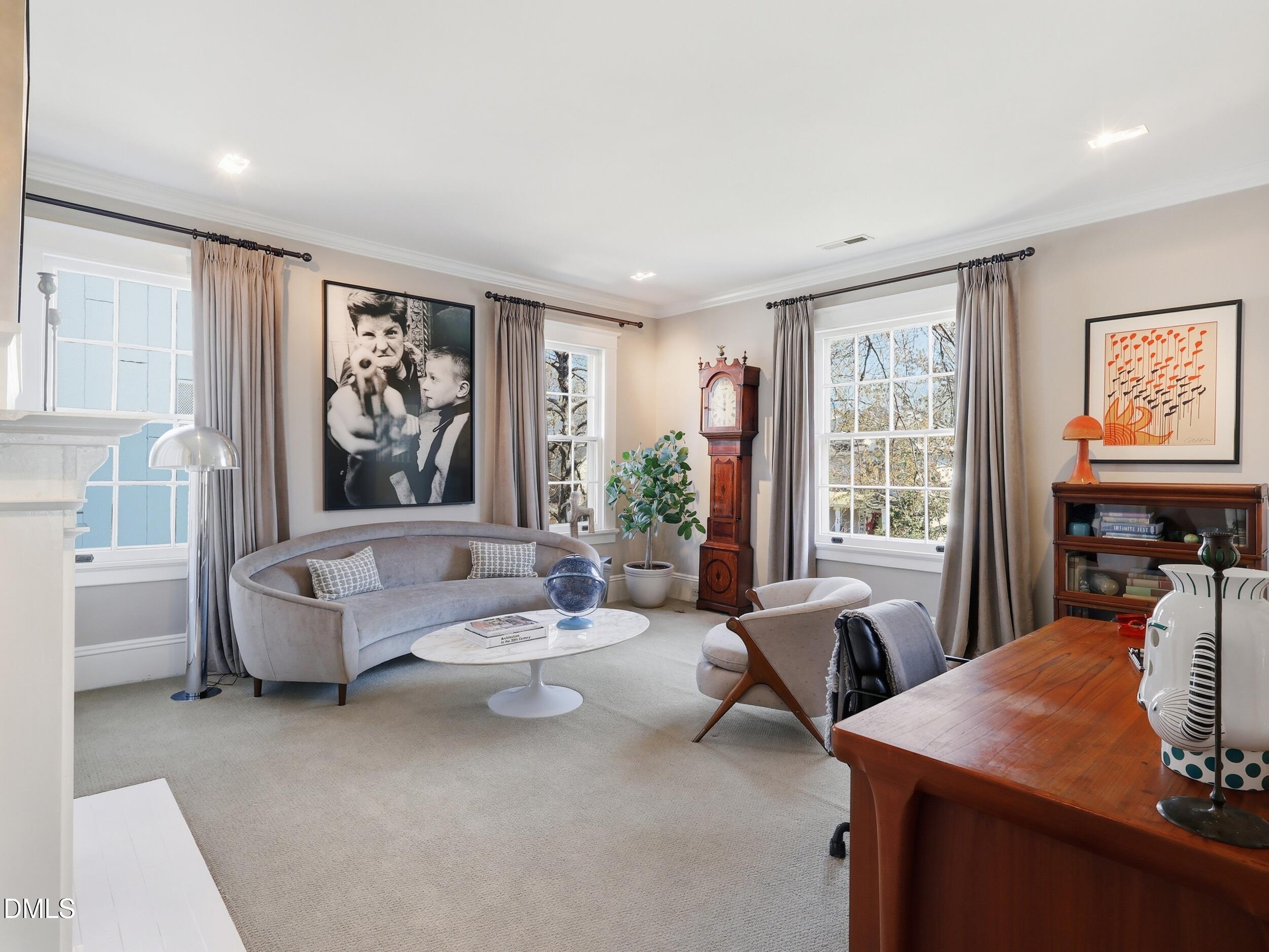 117 Hillcrest Road Raleigh, NC 27605 - Photo 53 of 80 a living room with furniture a window and a flat screen tv