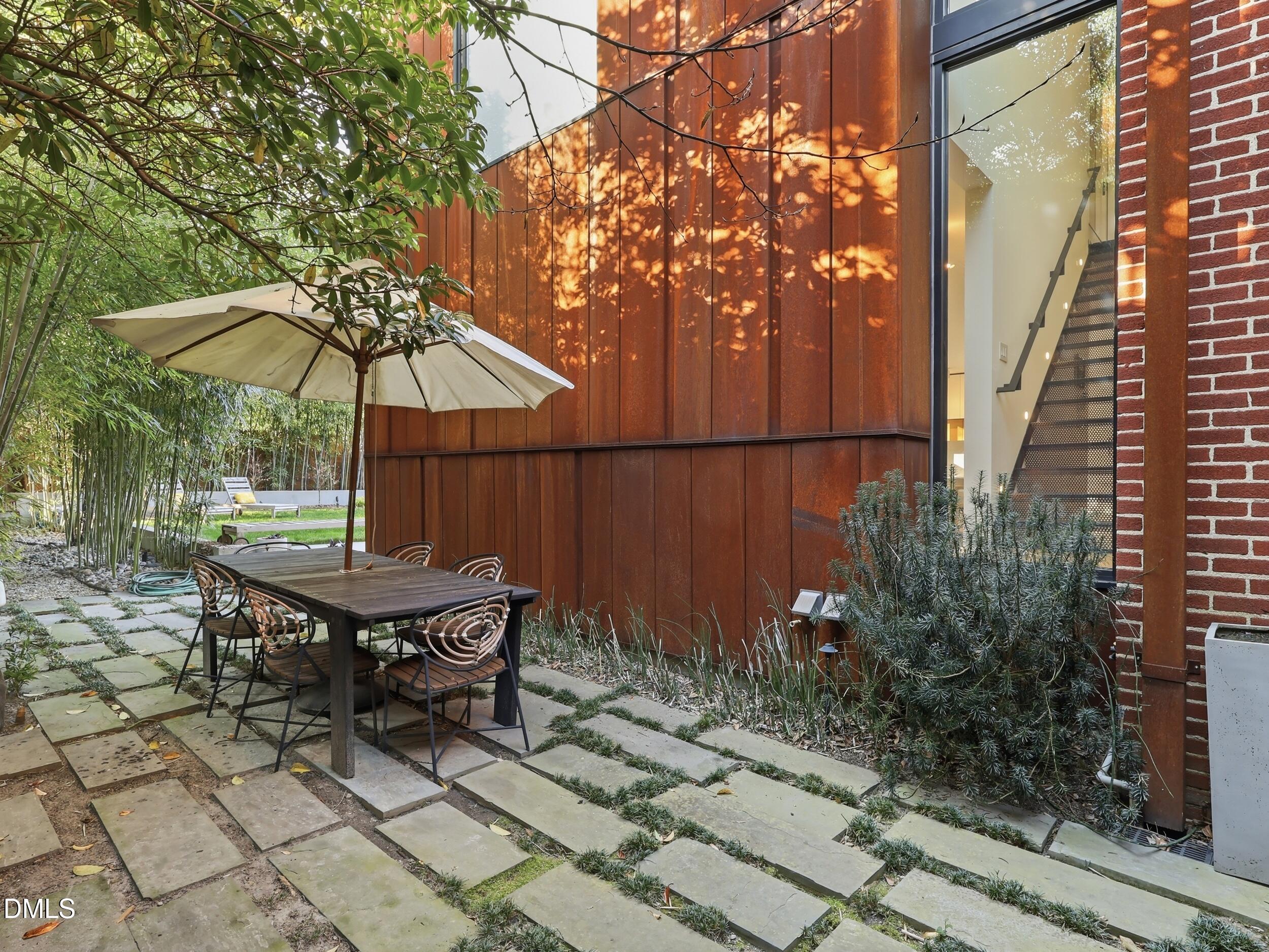 117 Hillcrest Road Raleigh, NC 27605 - Photo 69 of 80 a backyard of a house with table and chairs