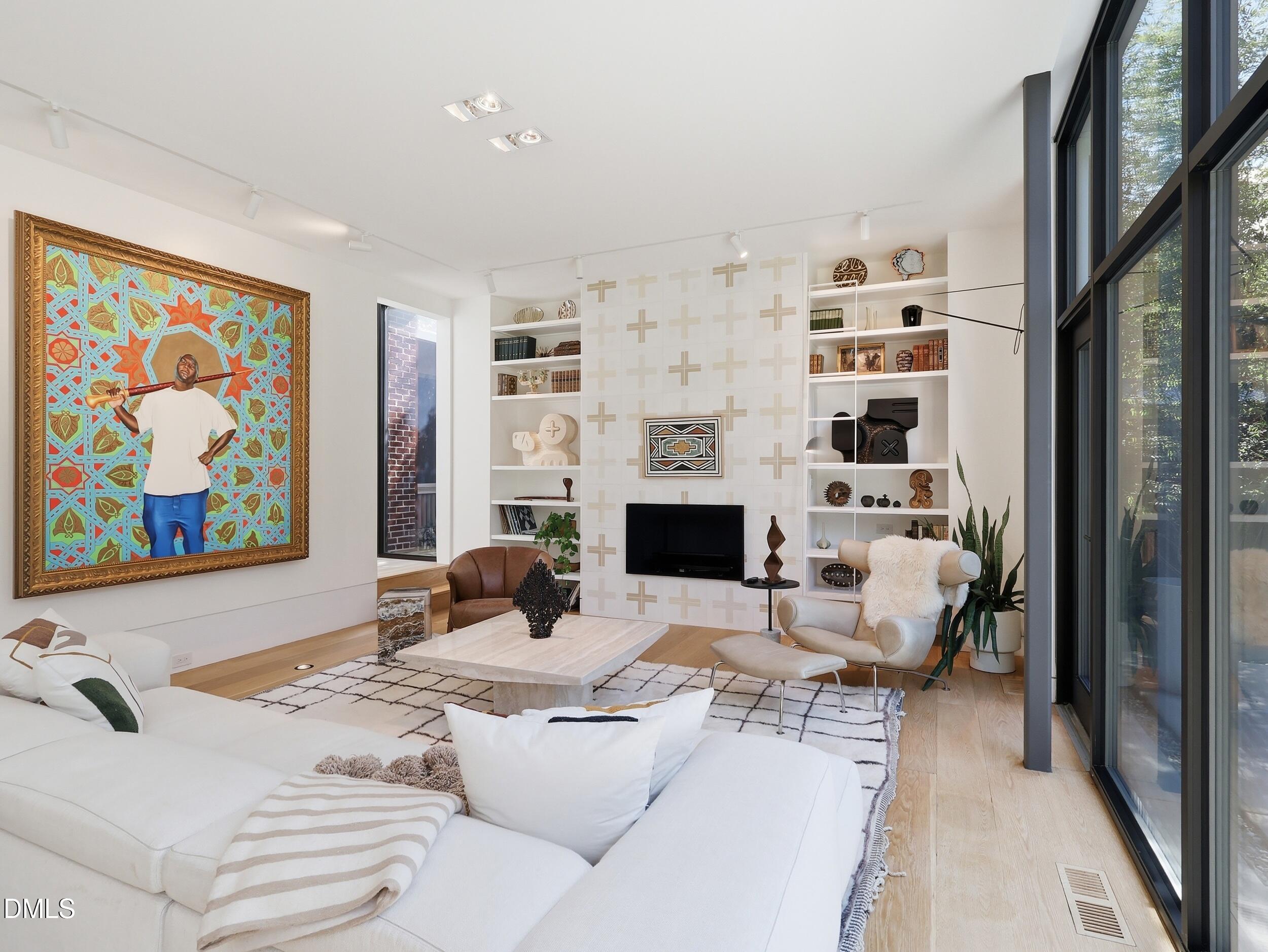 117 Hillcrest Road Raleigh, NC 27605 - Photo 7 of 80 a living room with furniture a fireplace and a large window