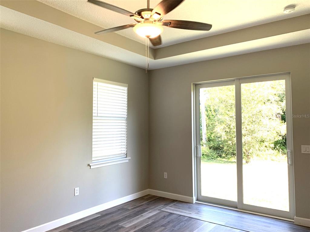 7410 Ellis Lane Port Charlotte, FL 33981 - Photo 12 of 23 a view of an empty room with wooden floor and a window