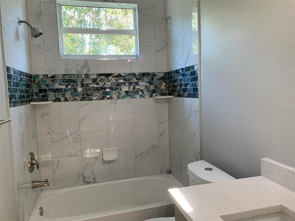 7410 Ellis Lane Port Charlotte, FL 33981 - Photo 19 of 23 a bathroom with a bathtub and shower