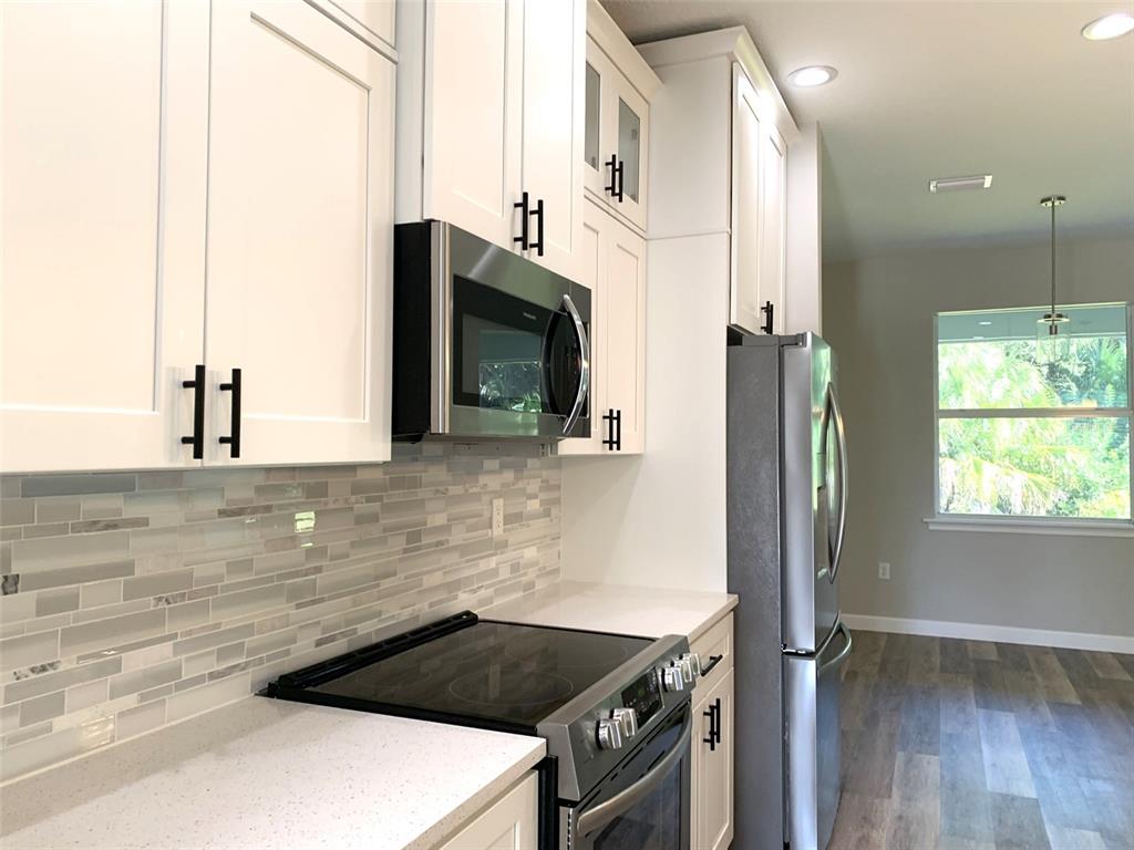 7410 Ellis Lane Port Charlotte, FL 33981 - Photo 4 of 23 a kitchen with granite countertop a sink and a stove top oven