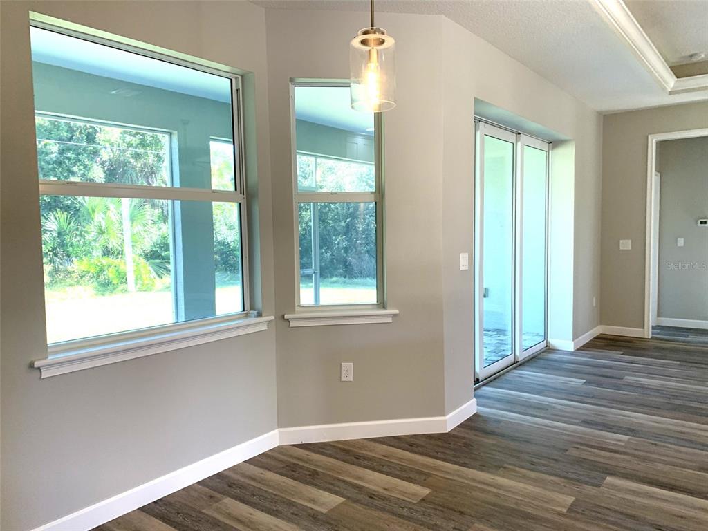 7410 Ellis Lane Port Charlotte, FL 33981 - Photo 6 of 23 an empty room with wooden floor and windows