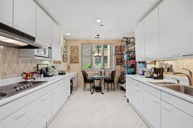 a kitchen that has a lot of cabinets in it