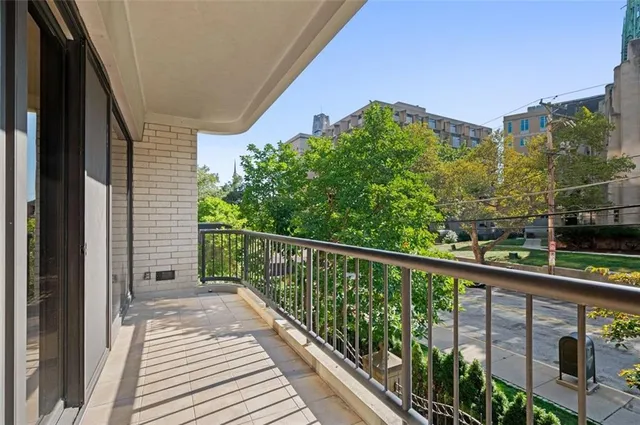 a view of a balcony with wooden floor and fence