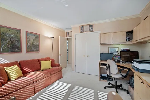 a view of a livingroom with workspace and a couch