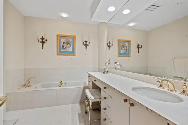 a bathroom with a granite countertop sink mirror and double