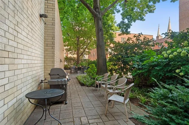 a backyard of a house with dining table and chairs