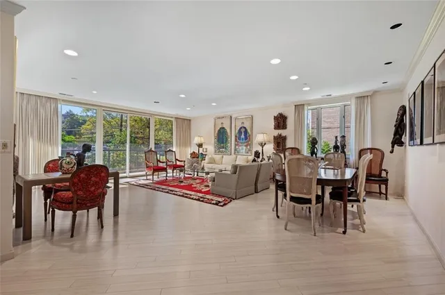 a living room with lots of furniture and a large window