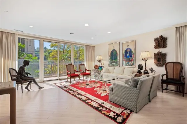 a living room with furniture and a floor to ceiling window