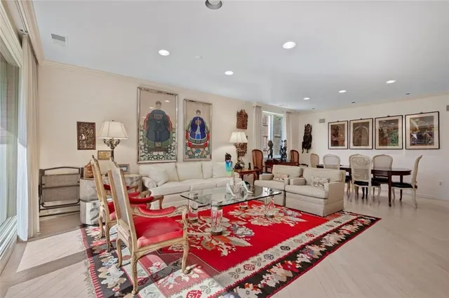 a living room with furniture a table and kitchen view