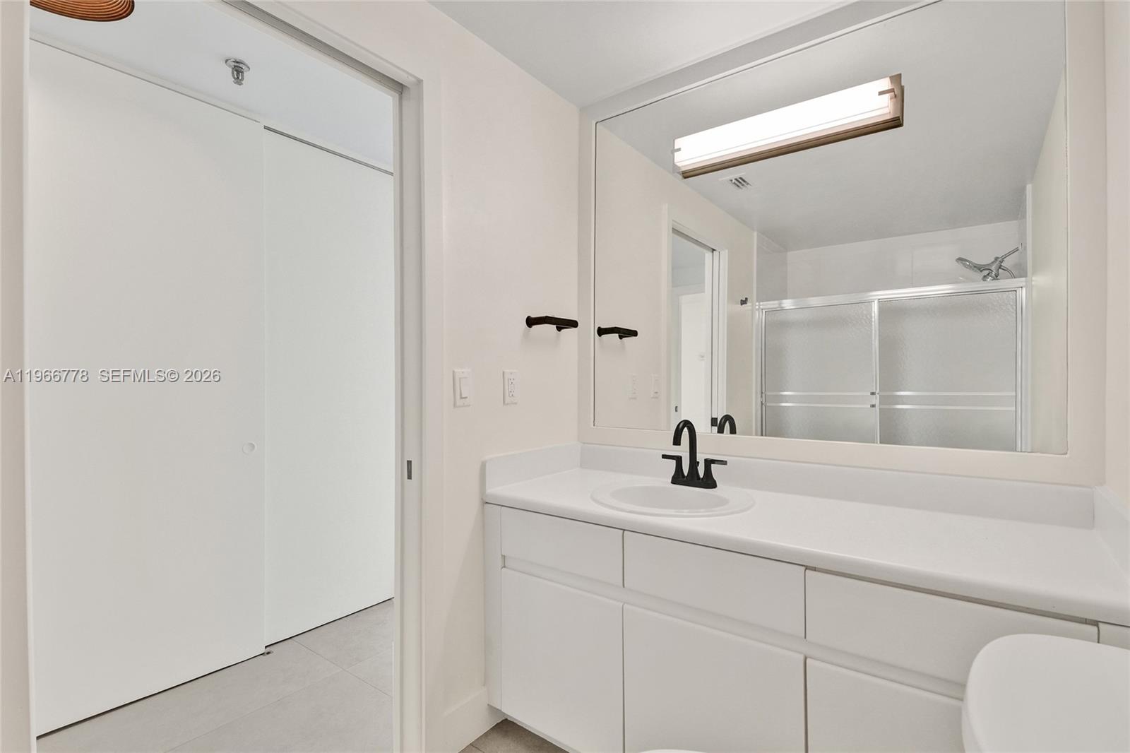 1834 Brickell Avenue, Unit 31 Miami, FL 33129 - Photo 13 of 35 a bathroom with a sink and a mirror