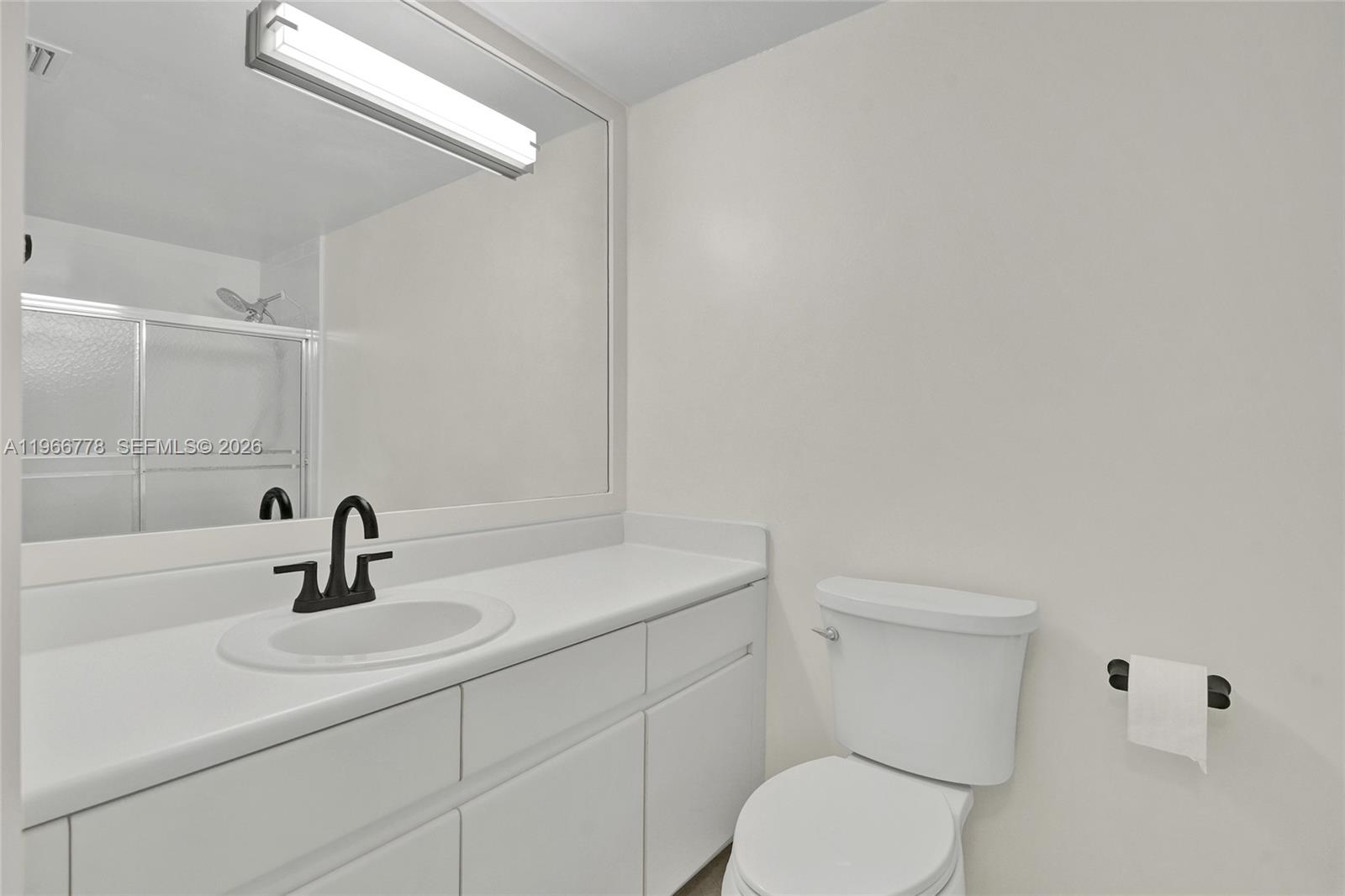 1834 Brickell Avenue, Unit 31 Miami, FL 33129 - Photo 14 of 35 a bathroom with a sink toilet and mirror