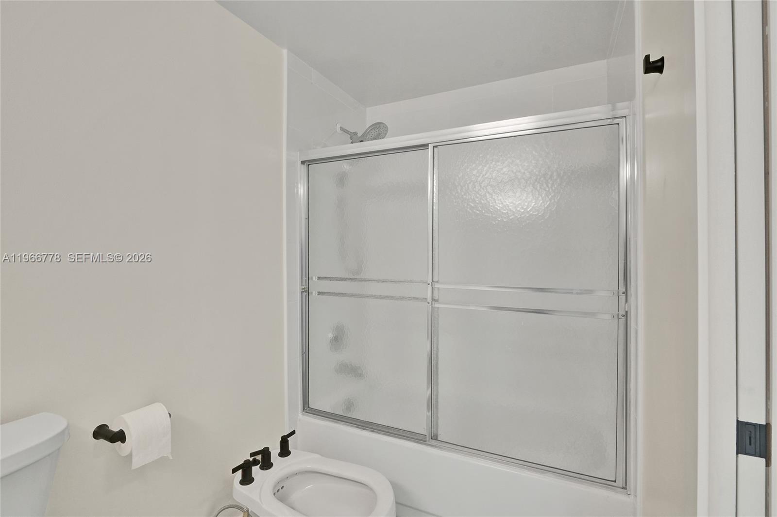 1834 Brickell Avenue, Unit 31 Miami, FL 33129 - Photo 15 of 35 a bathroom with a granite countertop sink vanity mirror and toilet