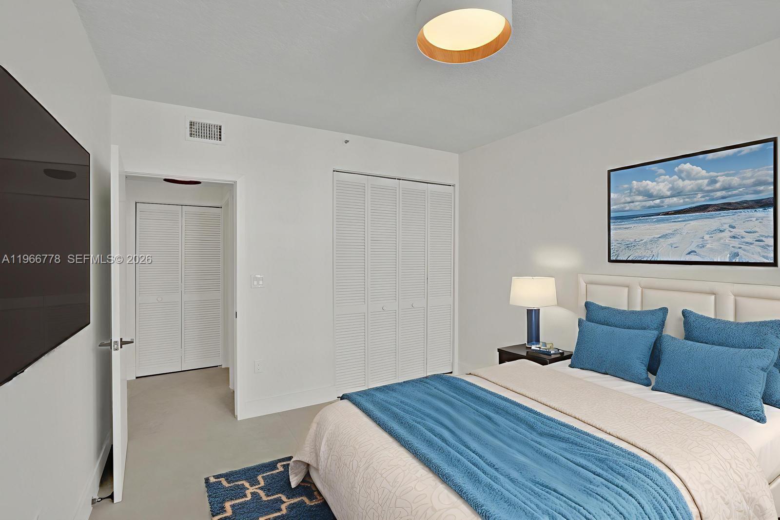 1834 Brickell Avenue, Unit 31 Miami, FL 33129 - Photo 16 of 35 a bedroom with a bed and a painting on the wall