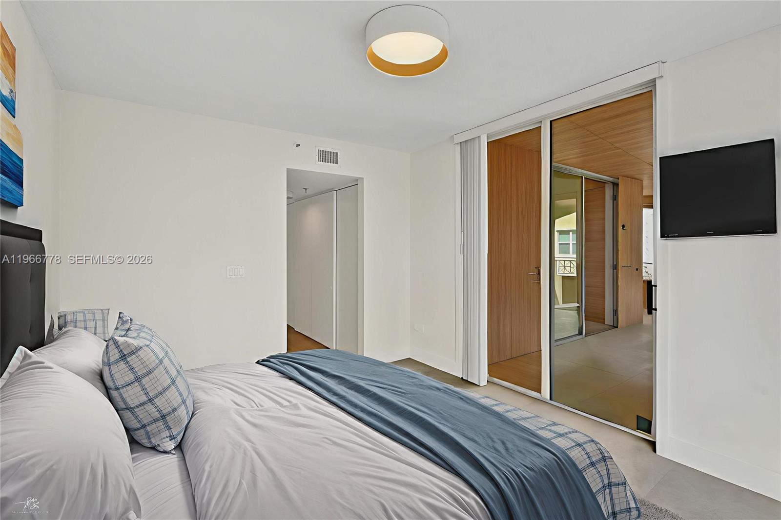 1834 Brickell Avenue, Unit 31 Miami, FL 33129 - Photo 8 of 35 a bedroom with a bed and a flat screen tv