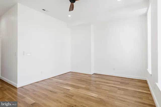 a view of a room with wooden floor