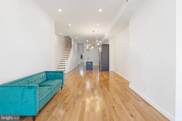 a view of kitchen and hall with wooden floor