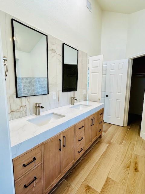17119 Upper Bay Road Addison, TX 75001 - Photo 9 of 29 a bathroom with double vanity sink and mirror