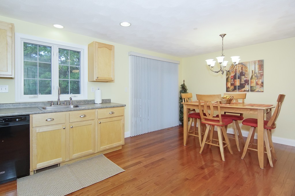 81 Salem Road, Unit 101 Billerica, MA 01821 - Photo 11 of 30 a dining room with chandelier and wooden floor