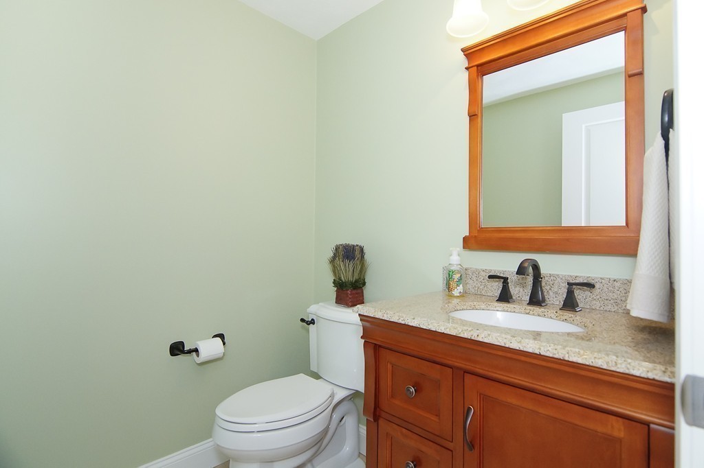81 Salem Road, Unit 101 Billerica, MA 01821 - Photo 18 of 30 a bathroom with a granite countertop toilet sink and mirror