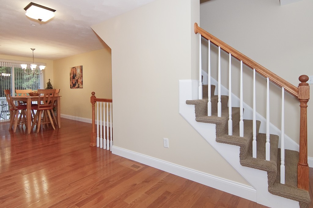 81 Salem Road, Unit 101 Billerica, MA 01821 - Photo 20 of 30 a view of a hallway with wooden floor and dining room