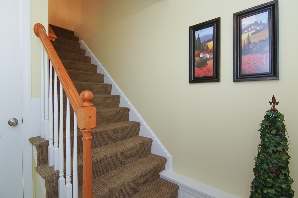 81 Salem Road, Unit 101 Billerica, MA 01821 - Photo 21 of 30 a view of staircase with wooden floor and a potted plant