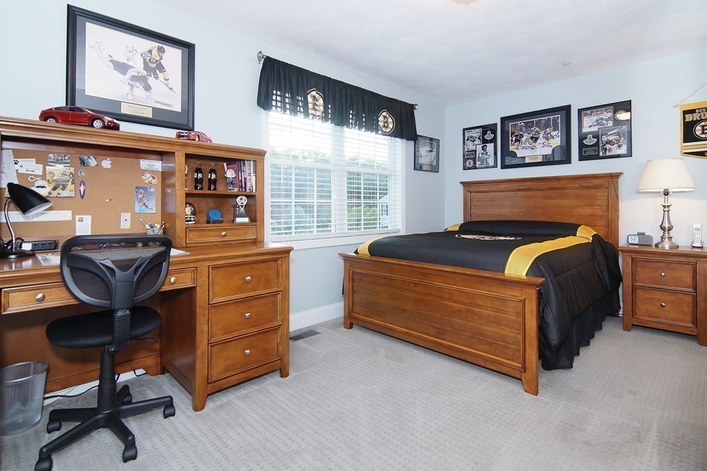 81 Salem Road, Unit 101 Billerica, MA 01821 - Photo 25 of 30 a bedroom with a bed and furniture