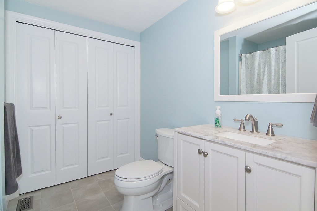 81 Salem Road, Unit 101 Billerica, MA 01821 - Photo 27 of 30 a bathroom with a granite countertop sink and a toilet