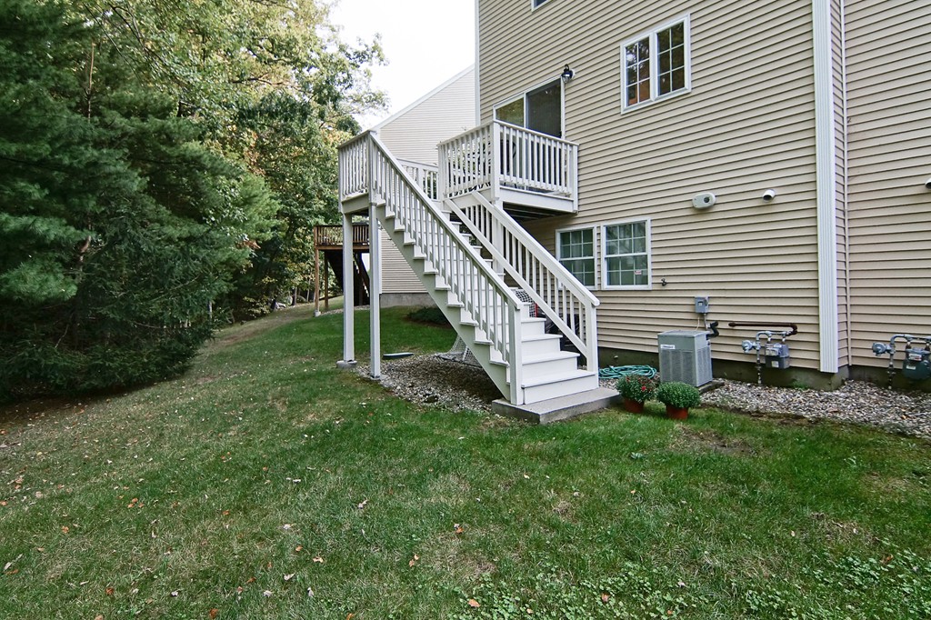 81 Salem Road, Unit 101 Billerica, MA 01821 - Photo 6 of 30 a view of a house with a yard