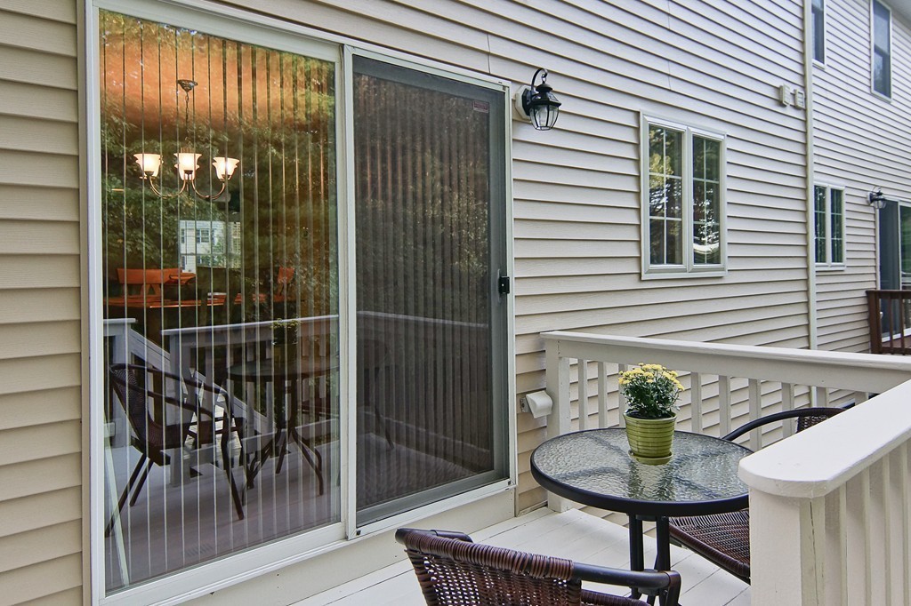 81 Salem Road, Unit 101 Billerica, MA 01821 - Photo 8 of 30 a balcony with table and chairs
