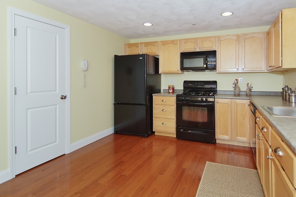 81 Salem Road, Unit 101 Billerica, MA 01821 - Photo 10 of 30 a kitchen with stainless steel appliances granite countertop a refrigerator stove and sink