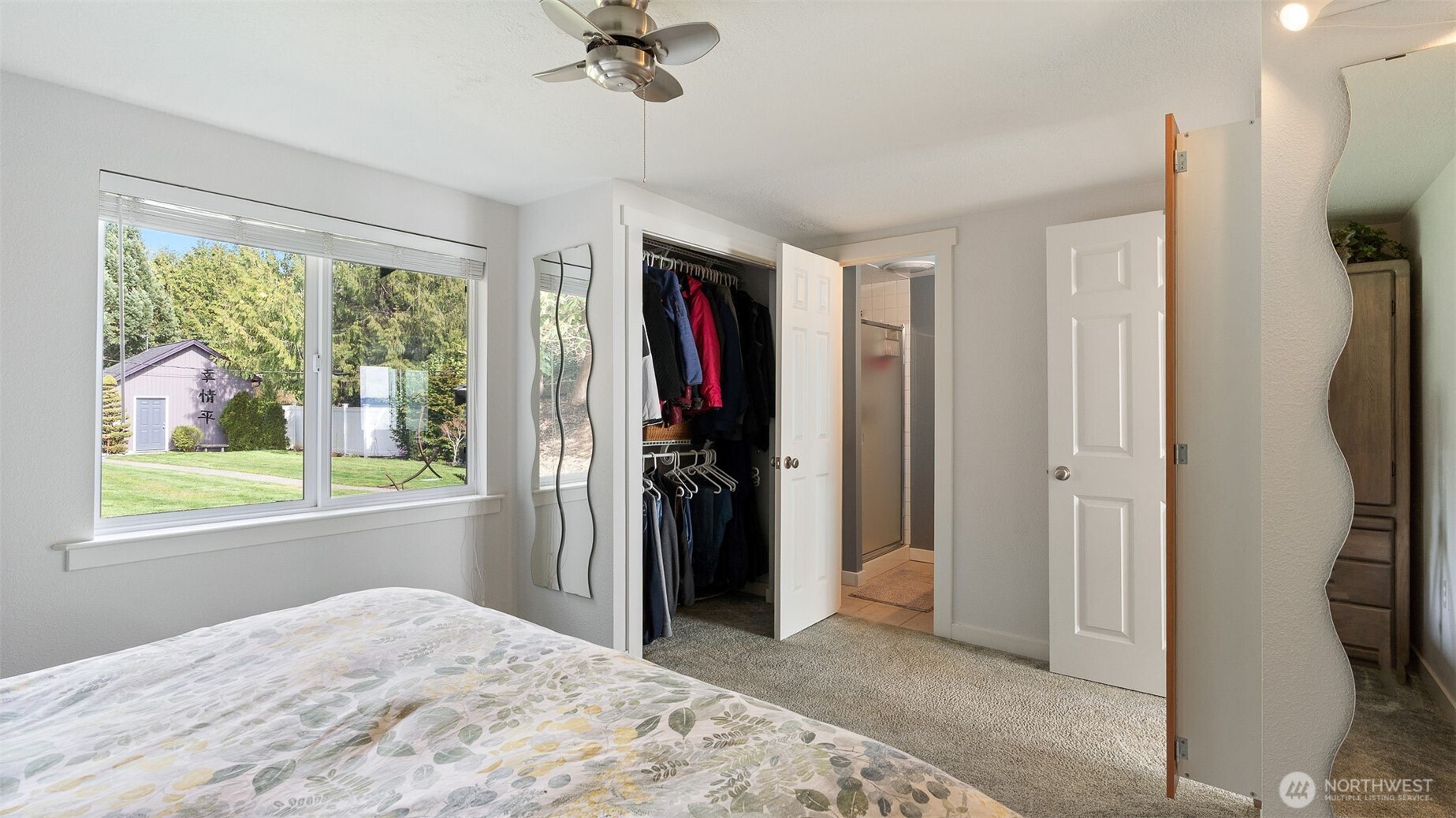 1406 Potlatch Beach Road Marysville, WA 98271 - Photo 13 of 40 a view of a bedroom with closet window and a ceiling fan