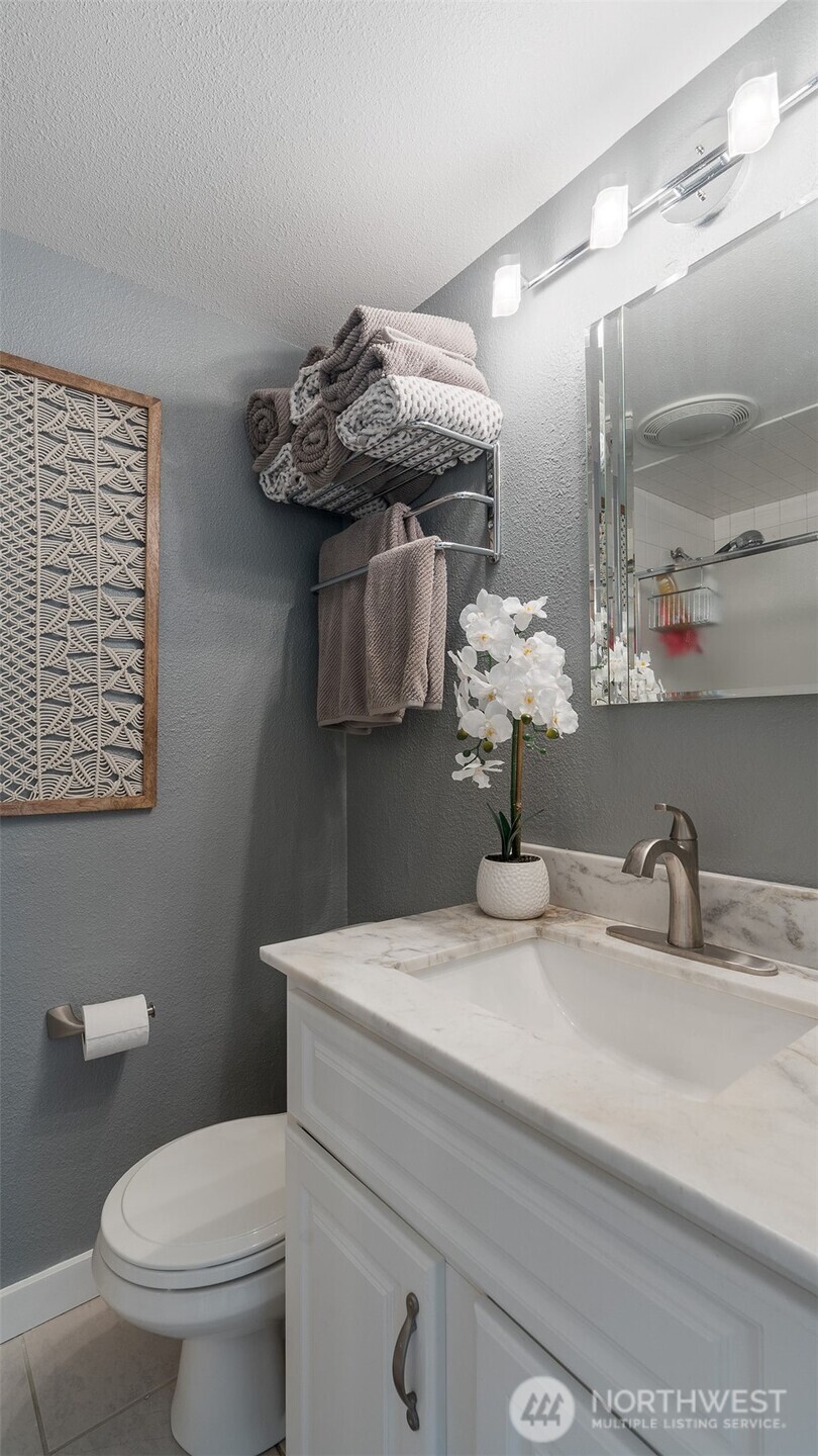 1406 Potlatch Beach Road Marysville, WA 98271 - Photo 14 of 40 a bathroom with a sink a toilet and mirror