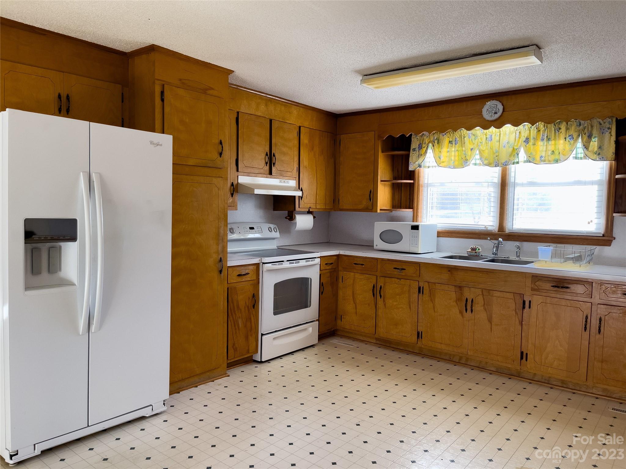 406 Fair Street Bethune, SC 29009 - Photo 11 of 28 a kitchen with a refrigerator sink and cabinets