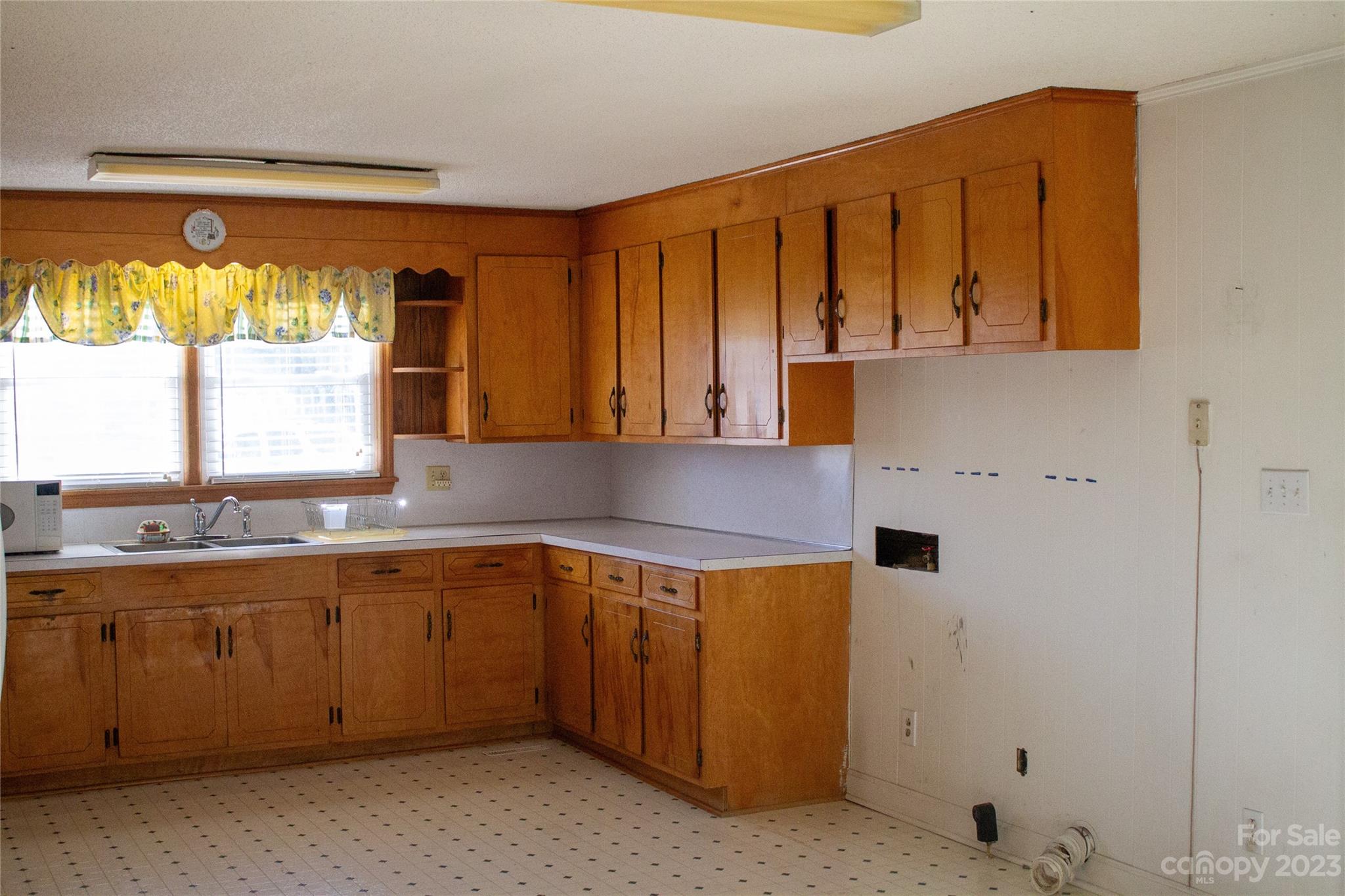 406 Fair Street Bethune, SC 29009 - Photo 14 of 28 a kitchen with a sink window and cabinets