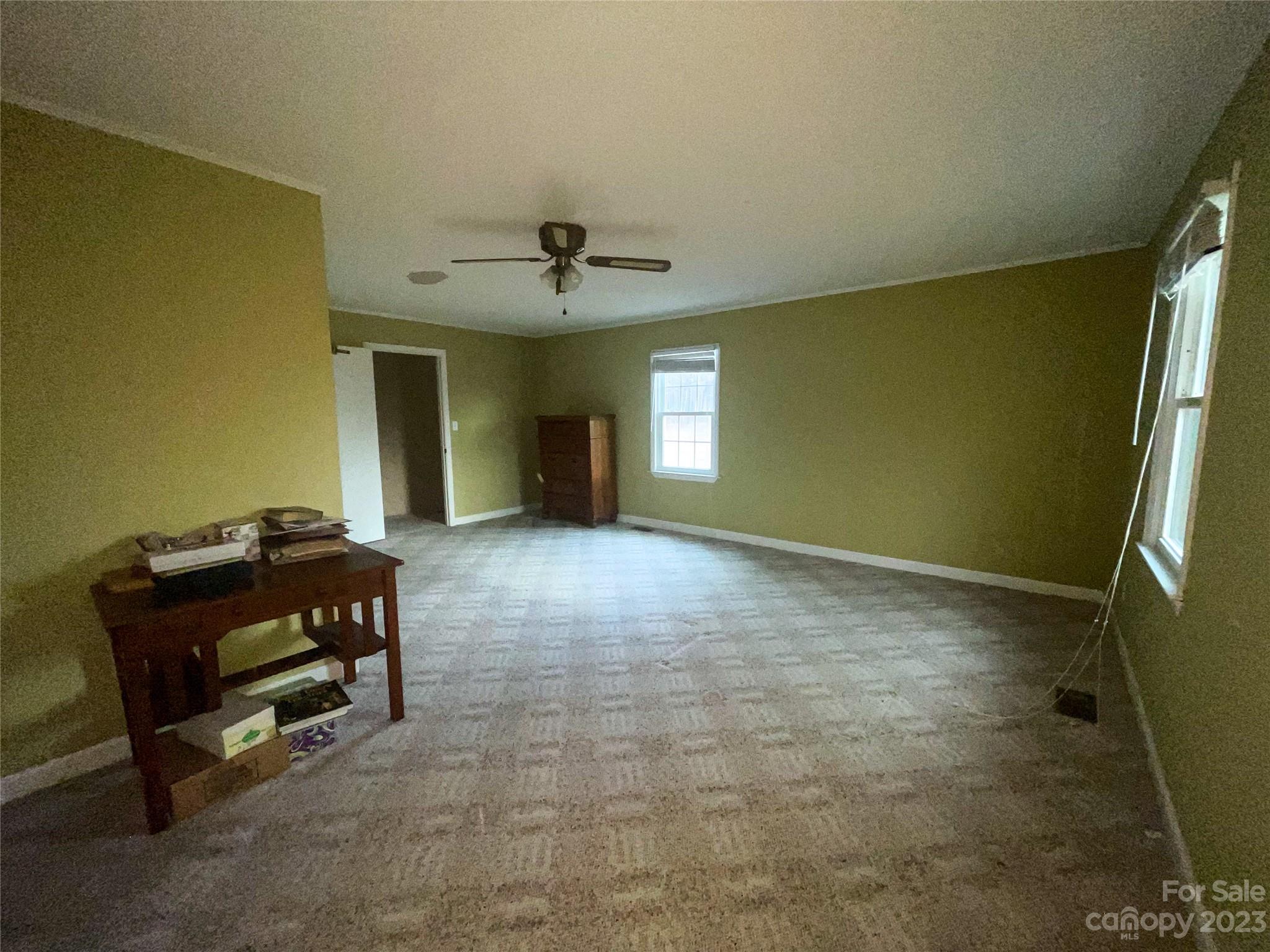 406 Fair Street Bethune, SC 29009 - Photo 19 of 28 a living room with furniture and a chandelier