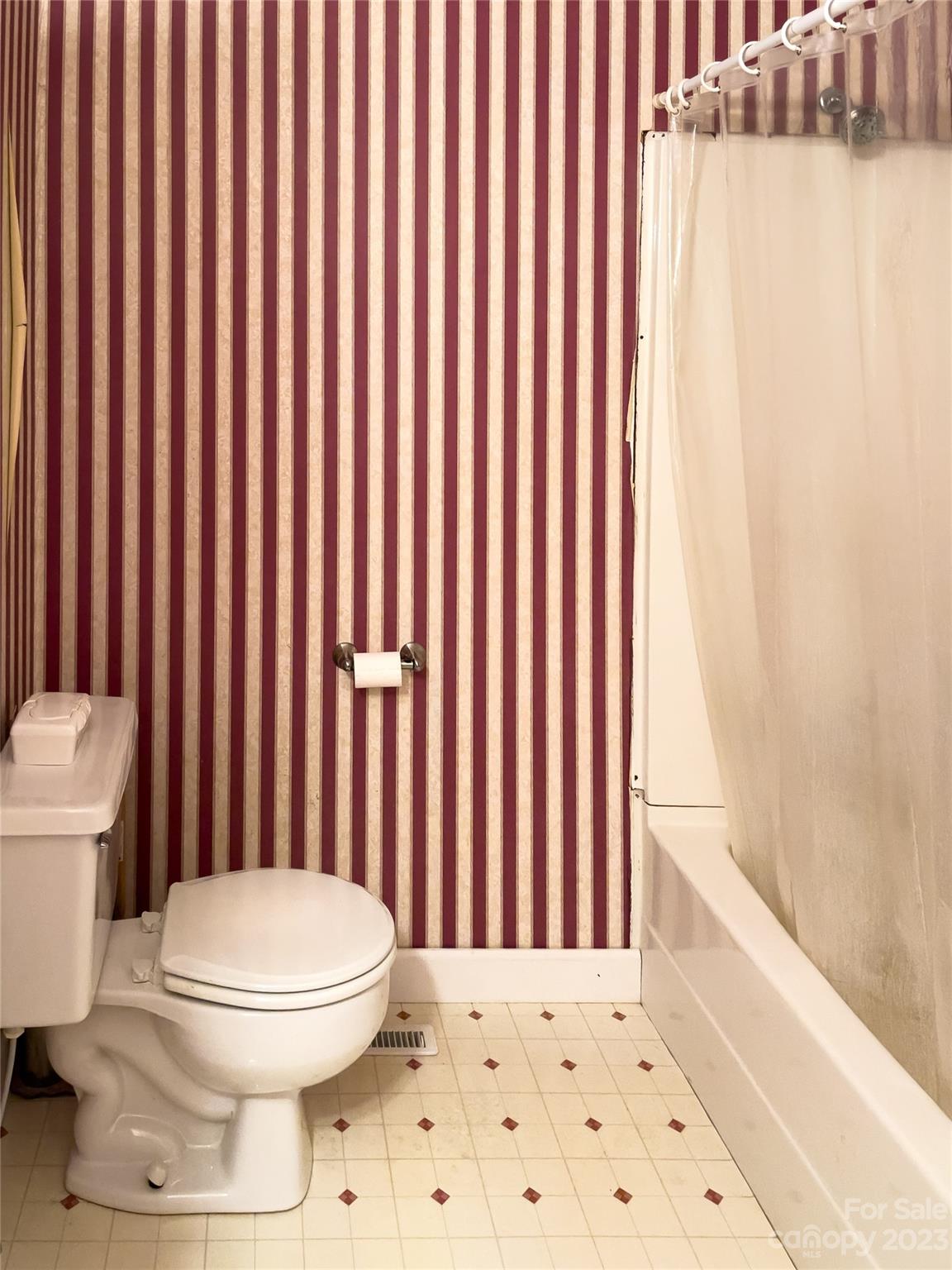 406 Fair Street Bethune, SC 29009 - Photo 20 of 28 a bathroom with a toilet and a shower curtain