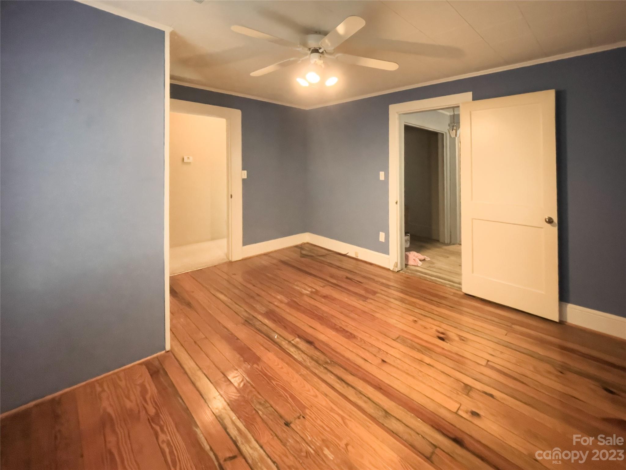 406 Fair Street Bethune, SC 29009 - Photo 24 of 28 an empty room with wooden floor and natural light