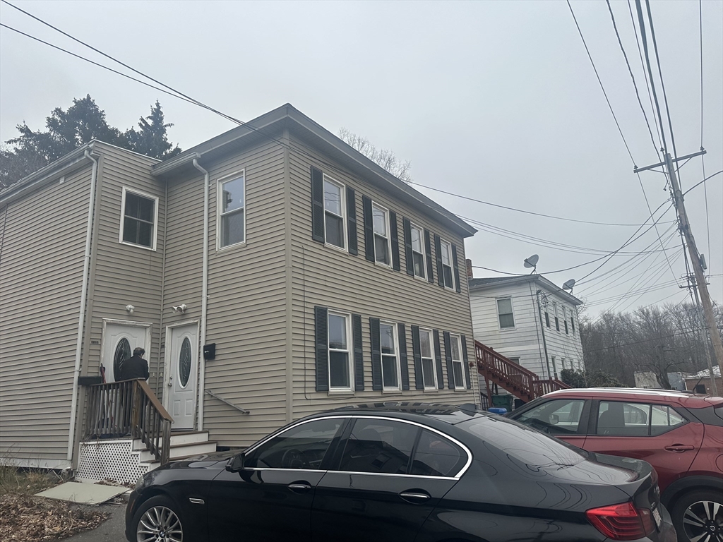 a front view of a house with parking space